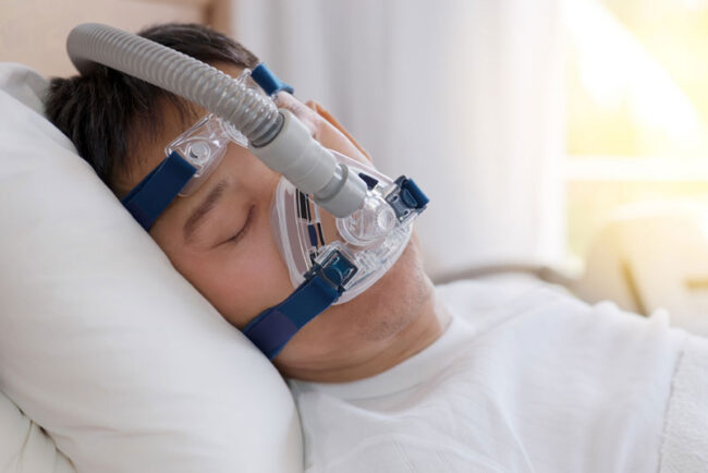 sleep-apnea-patient-using-cpap-machine Sleep Apnea Patient