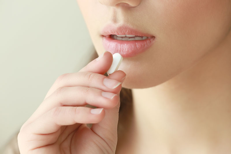Dental Patient Taking A Sedation Pill