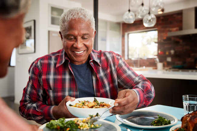 dental-implants-patient-eating Dental Implant Patient Smiling While Eating