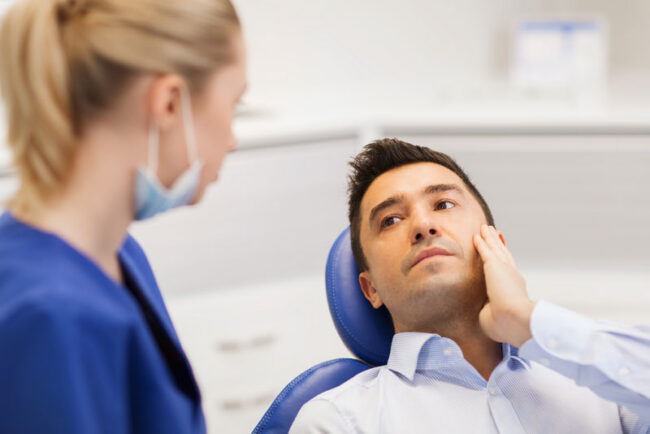 dental-patient-with-tooth-pain Dental Patient Experiencing Mouth Pain