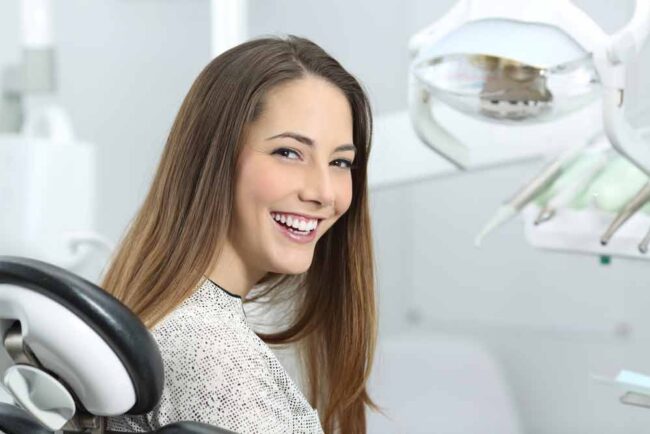 dental-patient-smiling-after-her-cosmetic-treatment a patient smiling after her professional teeth whitening