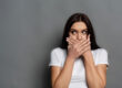 Dental Patient Covering Her Missing Tooth Shyly