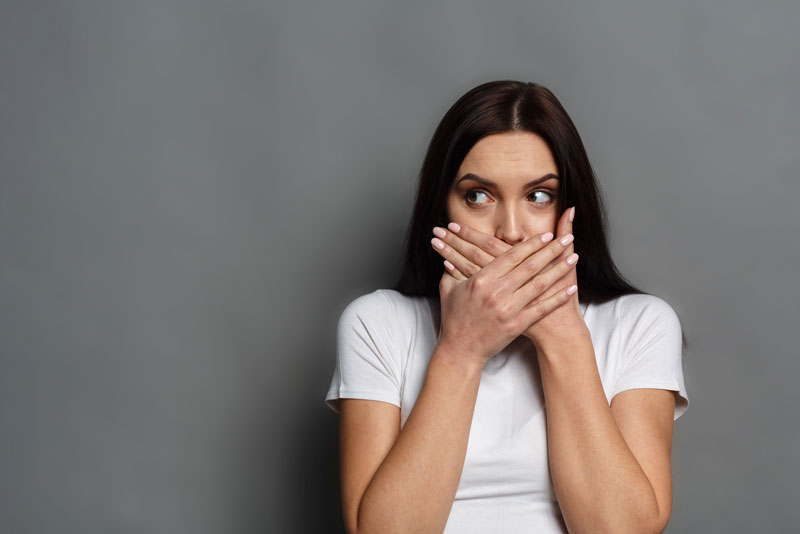 Dental Patient Covering Her Missing Tooth Shyly