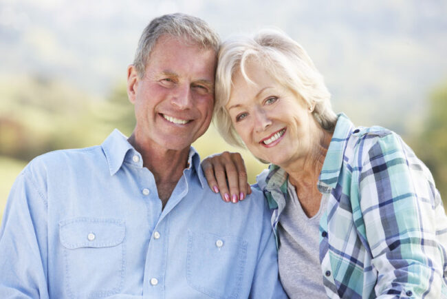 bone-grafting-patients-smiling Bone Grafting And Dental Implant Patients Smiling Together