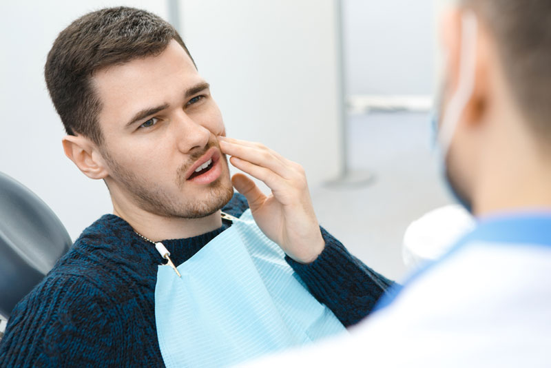 Dental Patient Suffering From Mouth Pain On A Dental Chair, In Westminster, CO