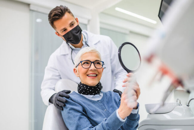 patient-getting-dental-implants a happy dental patient after affording dental implant surgery