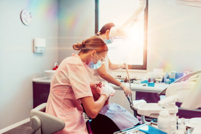 two-nurses-with-an-implant-patient two nurses placing dental implants for a dental patient.