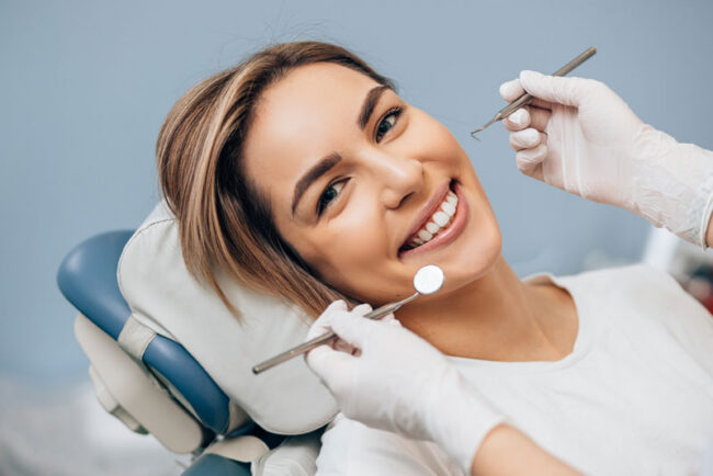 dental-implant-patient-smiling-during-exam a dental implant patient smiling during an exam.
