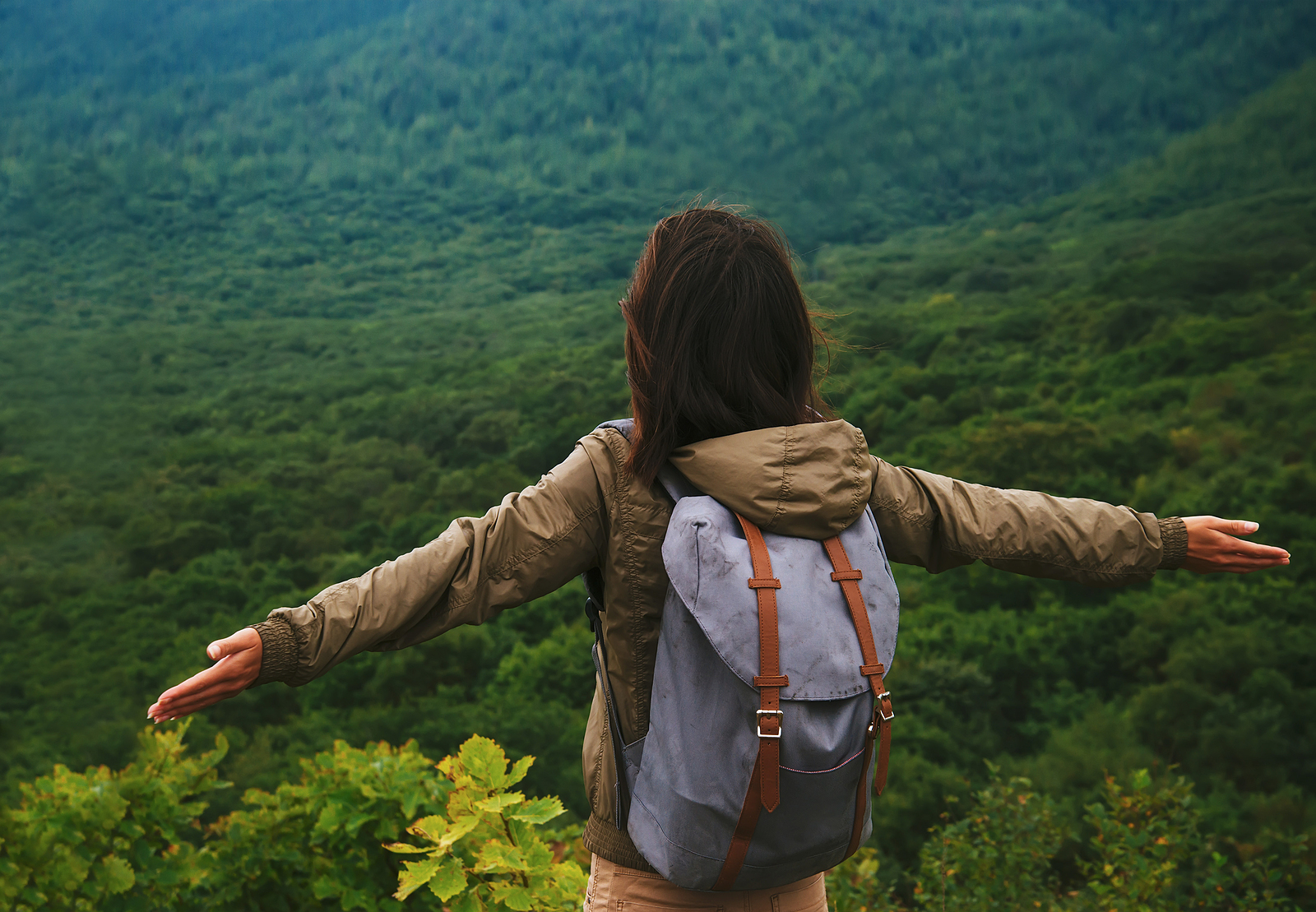 Hiker Woman Standing With Raised Arms On Mountain